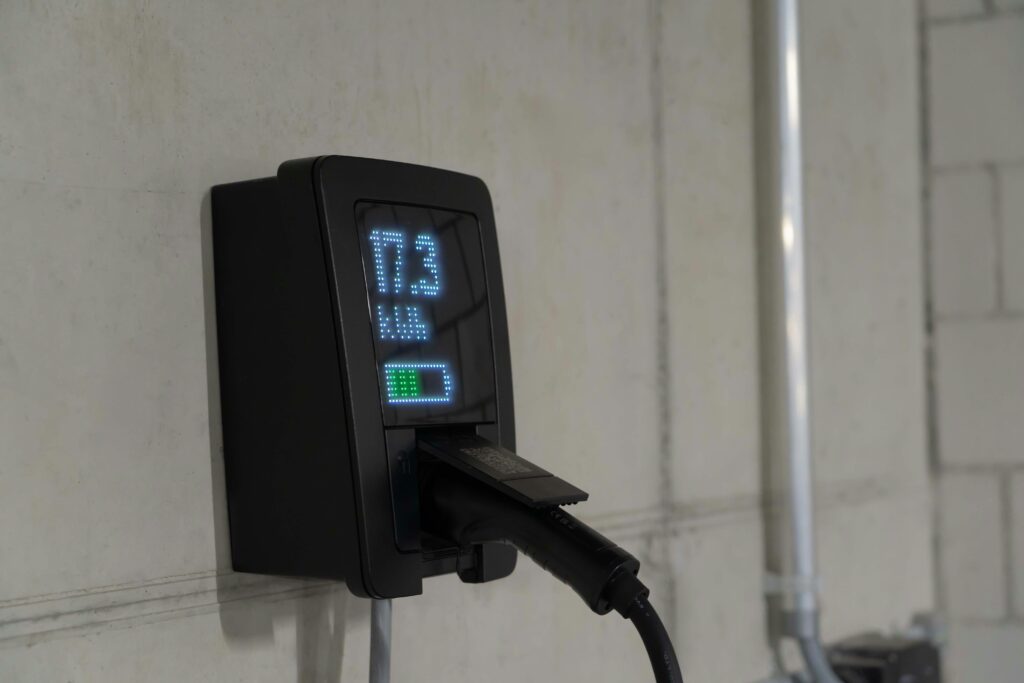 Detailed view of an electric vehicle charging station indoors, showcasing charging technology.